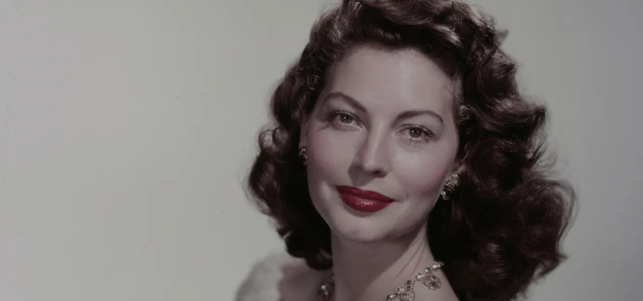 Ava Gardner, in colour, smiling over her shoulder